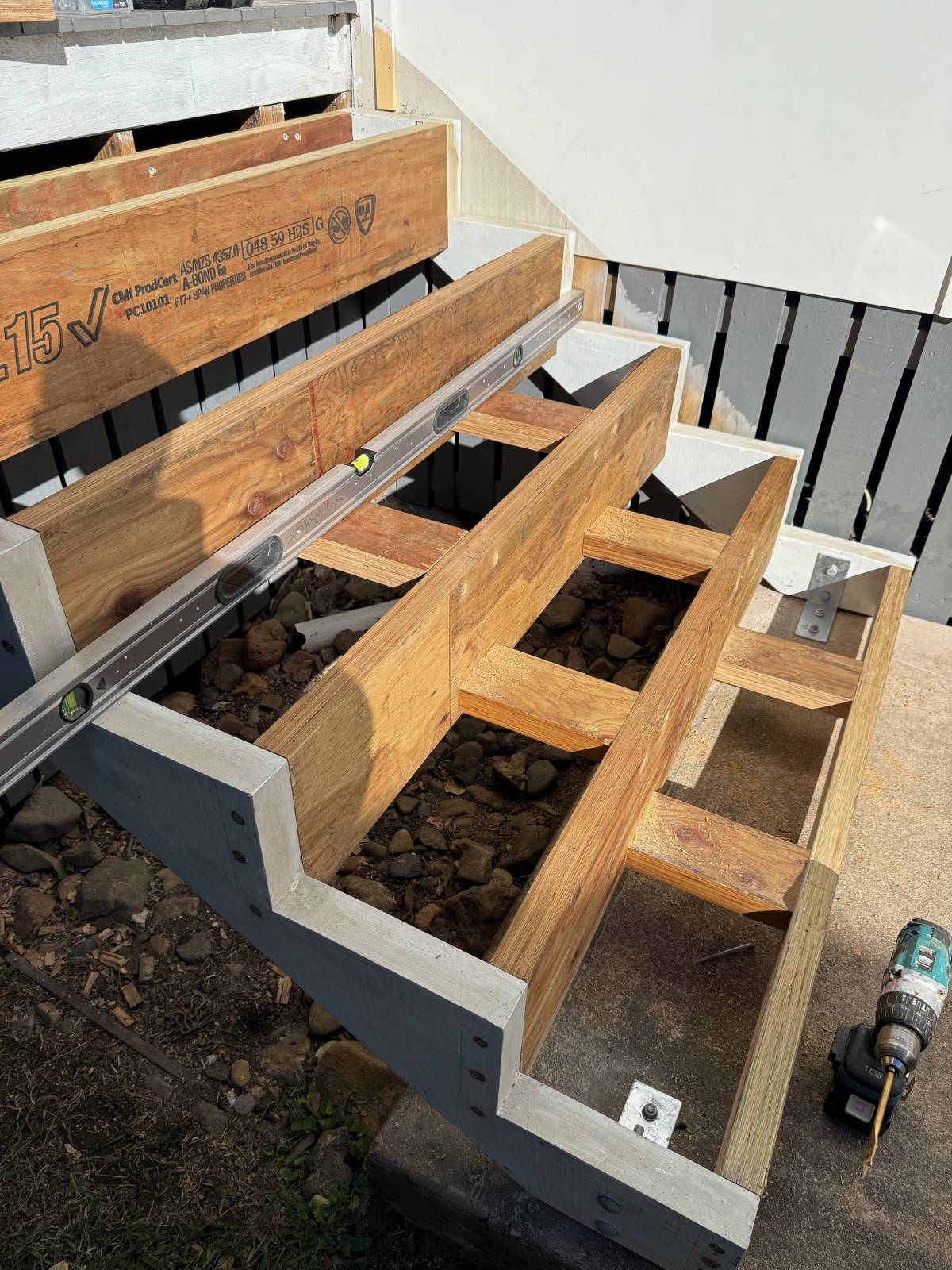 Steel stair stringers with new timber treads being fixed